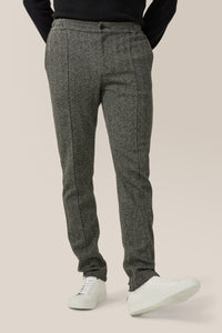 Model is wearing a size M Hollis Pant | Responsible Herringbone Cotton in color Black by Good Man Brand, view 3
