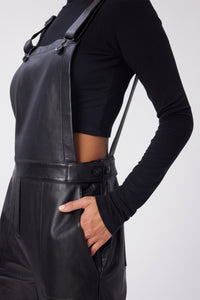 Maya is wearing a size 26 Overalls in Leather in color Black by LITA, view 6
