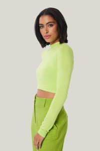 Cam is wearing a size S Young & Fun Long Sleeve Crop Mock Top in Rayon in color Acid Lime by LITA, view 2