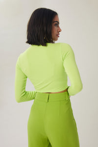 Cam is wearing a size S Young & Fun Long Sleeve Crop Mock Top in Rayon in color Acid Lime by LITA, view 5