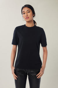 Annaly is wearing a size S Boxy Shoulder Pad Tee in Cotton in color Black by LITA, view 1
