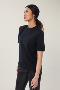 Annaly is wearing a size S Boxy Shoulder Pad Tee in Cotton in color Black by LITA, view 2
