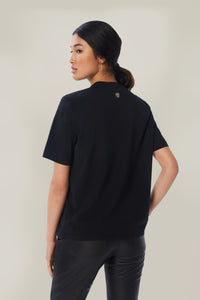 Annaly is wearing a size S Boxy Shoulder Pad Tee in Cotton in color Black by LITA, view 4
