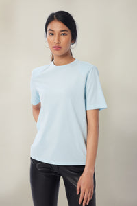 Annaly is wearing a size S Boxy Shoulder Pad Tee in Cotton in color Blue by LITA, view 6