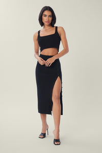 Cam is wearing a size M True Rib Skirt in Cotton in color Black by LITA, view 1