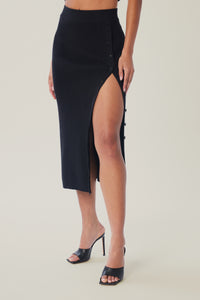 Cam is wearing a size M True Rib Skirt in Cotton in color Black by LITA, view 3