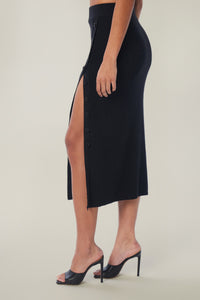 Cam is wearing a size M True Rib Skirt in Cotton in color Black by LITA, view 4