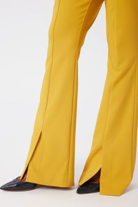 Model is wearing a size 0 Flared Leg Suit Pant in Crepe in color Saffron by LITA, view 4