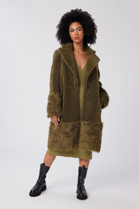 Imoni is wearing a size S The Teddy Coat in Faux Fur in color Olive by LITA, view 1