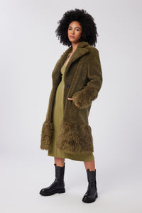 Imoni is wearing a size S The Teddy Coat in Faux Fur in color Olive by LITA, view 2