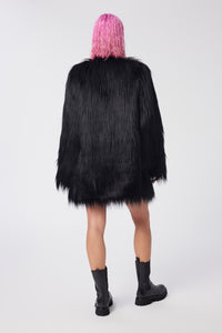 Cam is wearing a size S The Shag Faux Fur Coat in color Black by LITA, view 4