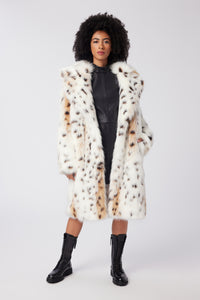 Imoni is wearing a size S Amour Coat in Snow Leopard Faux Fur in color Snow Leopard by LITA, view 1