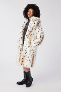 Imoni is wearing a size S Amour Coat in Snow Leopard Faux Fur in color Snow Leopard by LITA, view 2