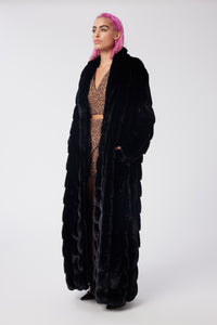 Cam is wearing a size S The Encore Coat in Faux Fur in color Black by LITA, view 2
